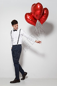 礼物气球爱心青年男人拿着心形气球背景