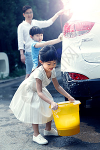 提着水桶的男孩快乐家庭擦洗汽车背景