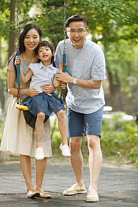 绿色亚洲人双亲家庭快乐的一家三口荡秋千图片