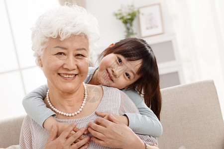 两个人拥抱儿童可爱的小女孩和祖母在客厅图片
