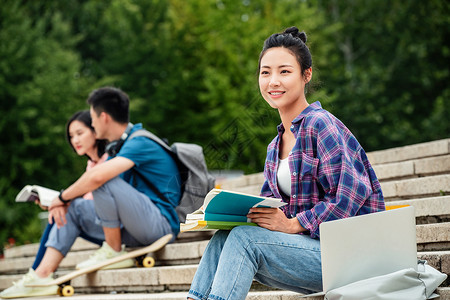 滑板运动学生快乐的大学生坐在台阶上背景