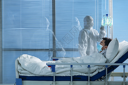 患者躺在医院病床上治疗高清图片素材