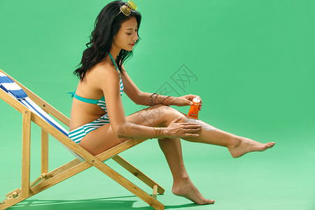 腿部涂抹防晒霜的泳装美女图片