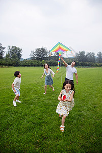 穿短袖的男孩青年夫妇垂直构图8到9岁快乐的一家四口在草地上放风筝背景