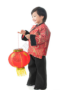 春节气氛一个小男孩手提红色灯笼庆祝新年图片
