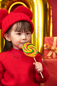 节日甜食传统庆典过新年的小女孩吃棒棒糖红色高清图片素材