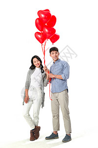 情人节幸福户内浪漫情侣拿着心形气球图片