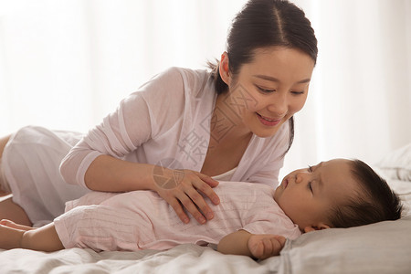 青年女人妈妈陪宝宝睡觉生长高清图片素材