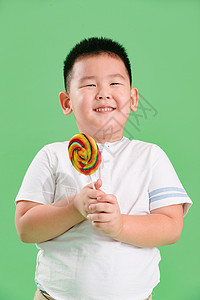 东方人摄影食品可爱的小男孩拿着棒棒糖成长高清图片素材