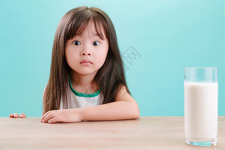 快乐表情包成长可爱的小女孩和一杯牛奶好奇心高清图片素材