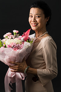 手拿一束康乃馨亚洲高贵财富手拿鲜花的优雅女士背景