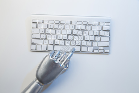 机械手触碰键盘数码科技智能机械手与键盘背景