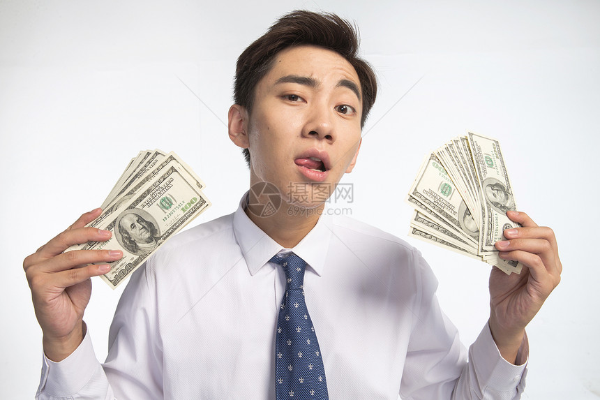 贪欲亚洲储蓄商务青年男人拿着美元图片