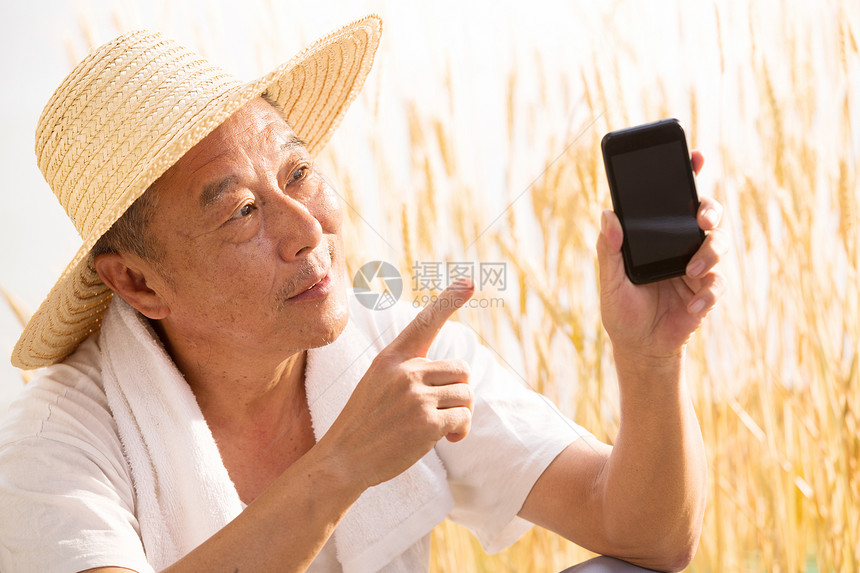 老农民拿着手机图片