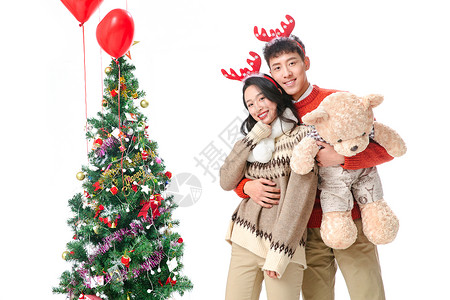女人幸福女朋友过圣诞节的青年情侣抱着玩具熊高清图片