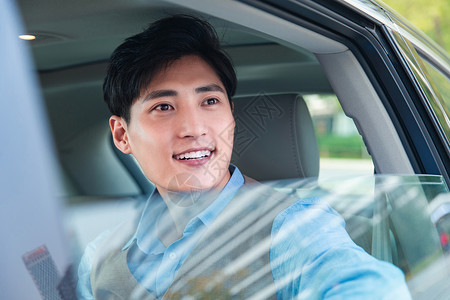 坐在汽车里往外看的商务青年亚洲人高清图片素材
