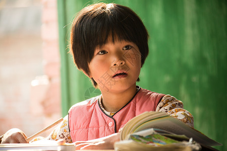 学习艰苦写字乡村小学里的小学女生背景图片