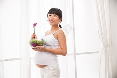 构图素材简单水平构图简单身体保养幸福的孕妇吃蔬菜沙拉背景