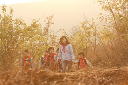 山区小学在校生关爱团结乡村女教师和学生在户外背景