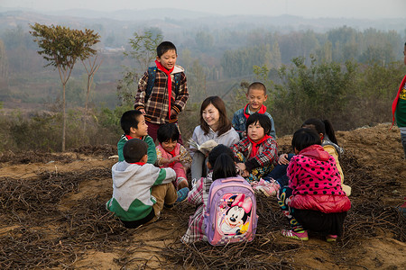 亚洲青年女人乡村教师和小学生在户外学习图片