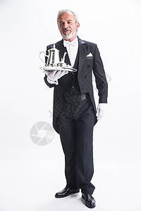 大魔术师仅男人礼节酒店职位一个男侍者托着银餐具背景