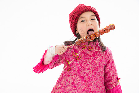 天真东方人季节欢乐的小女孩吃糖葫芦图片