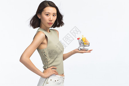肖像半身像亚洲青年女人手托着购物车图片