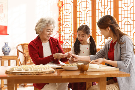 吃饺子的小孩传统庆典东方人人幸福家庭过年包饺子背景