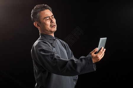 民国时期东方长袍复古中老年男人看手机背景图片
