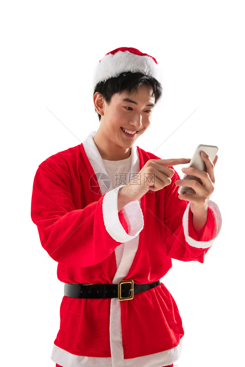 乐趣愉悦年轻人穿圣诞服的青年男人拿着手机图片