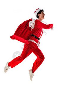 跳年轻人两腿分开穿圣诞服的青年男人背着礼物袋高清图片