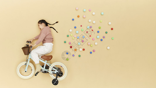 骑自行车的学生骑着自行车飞在空中的儿童形象背景