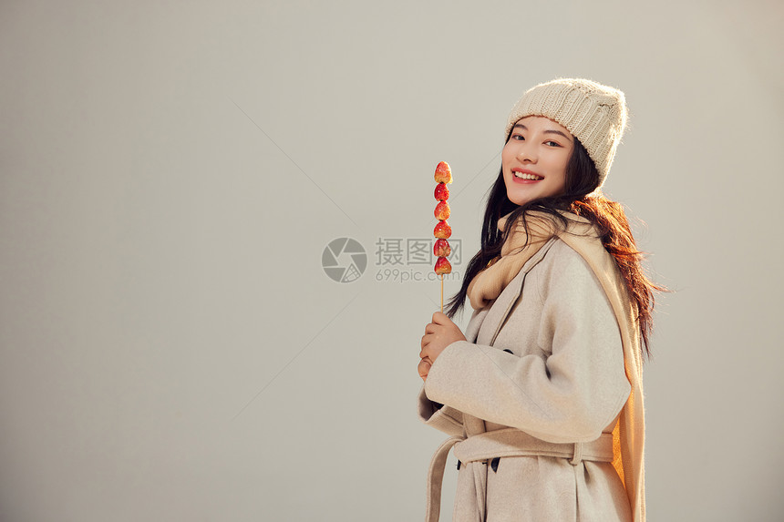 年轻美女手拿冰糖葫芦形象图片