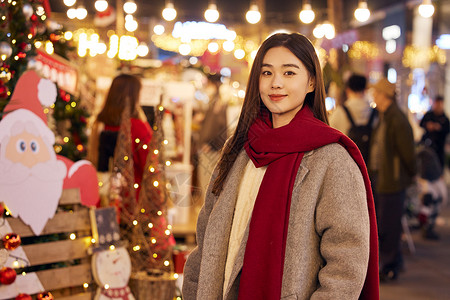 夜晚的圣诞老人冬日女性夜晚逛圣诞市集背景