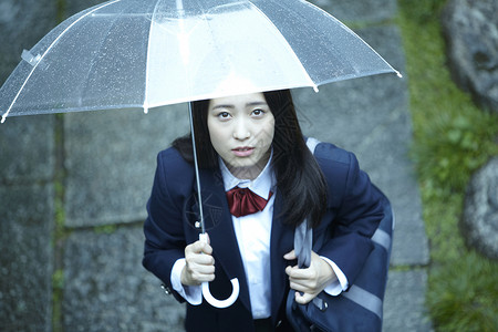 雨天撑伞上学的女高中生可爱高清图片素材