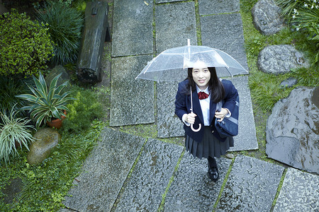 雨天撑伞上学的女高中生日本人高清图片素材