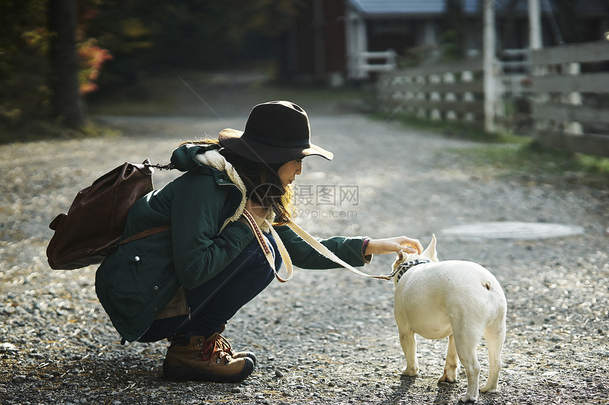 抚摸法国斗牛犬的妇女图片