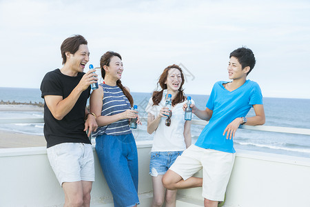 户外天台聚会度假青年喝饮料图片