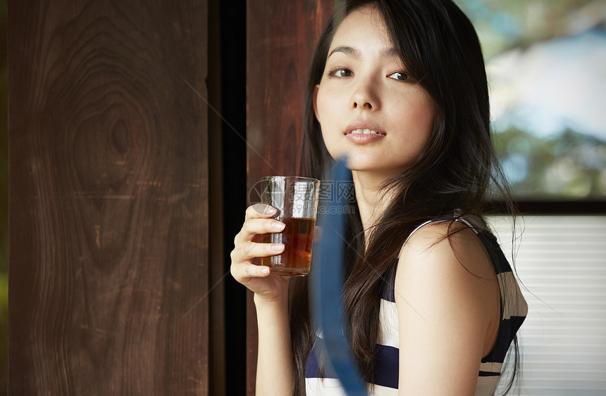 日式房屋中休息喝茶的女青年图片