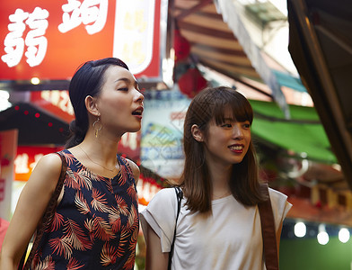 在夜市逛街的女性图片