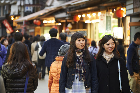 在街上人流中穿行的女游客宫岛背景图片