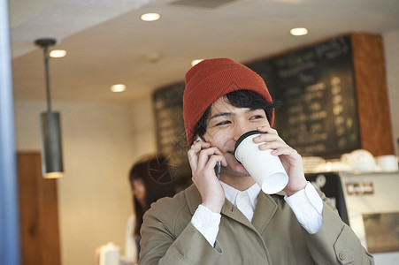 喝着咖啡打电话的男性图片