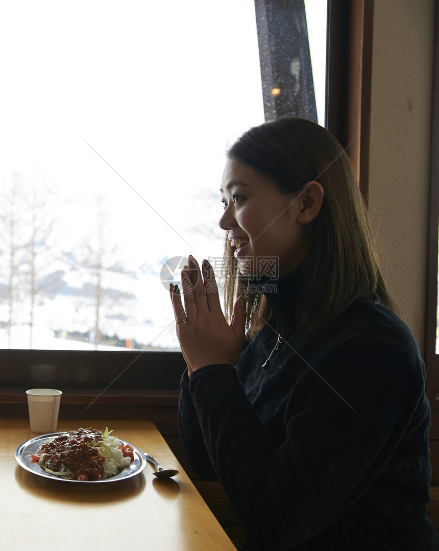 旅游度假区吃午饭的年轻女性图片