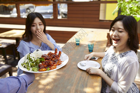 在餐厅享受美食的二个女孩食物高清图片素材