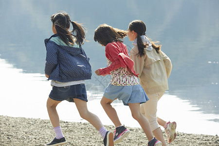 海滩上奔跑的小学生儿童高清图片素材