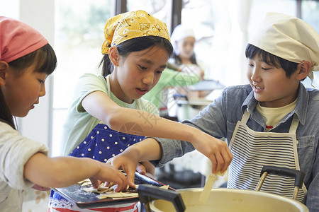 小学生在食堂学做饭同学高清图片素材