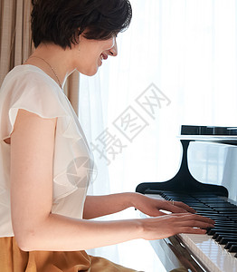 优雅弹钢琴的女性图片