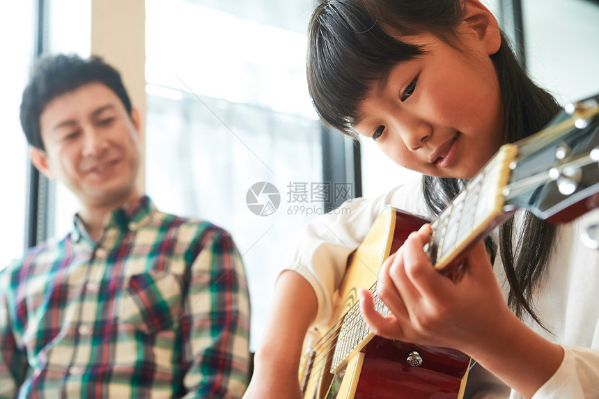 闲暇时间父亲教女儿弹吉他图片