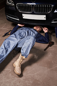躺在地上维修汽车的成年男子扳手高清图片素材