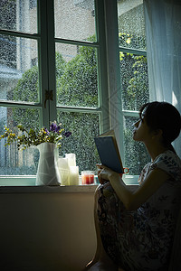 下雨天在窗边放松的女孩日本人高清图片素材